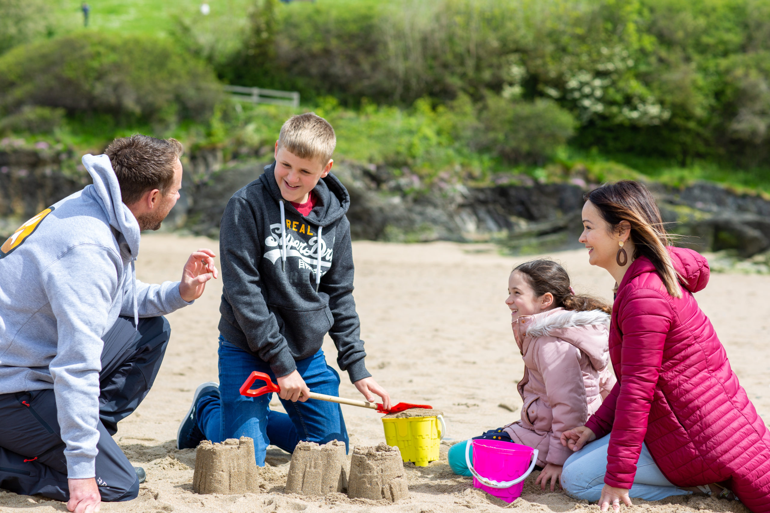 family playing in the sand
